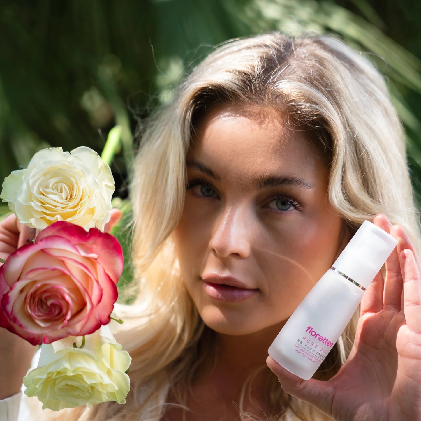 Model holding Florettee Rose Oil BB Face Cream with roses