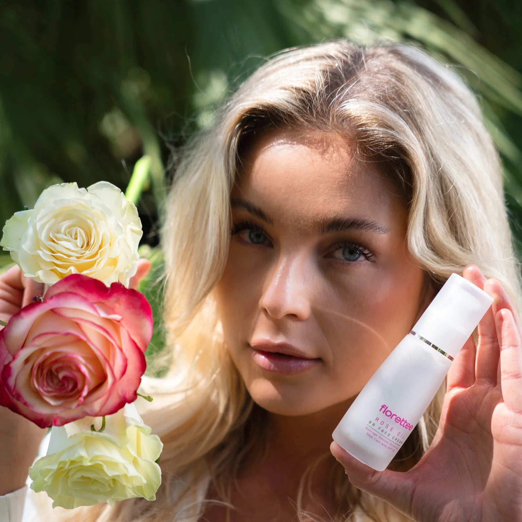 Model holding Florettee Rose Oil BB Face Cream with roses