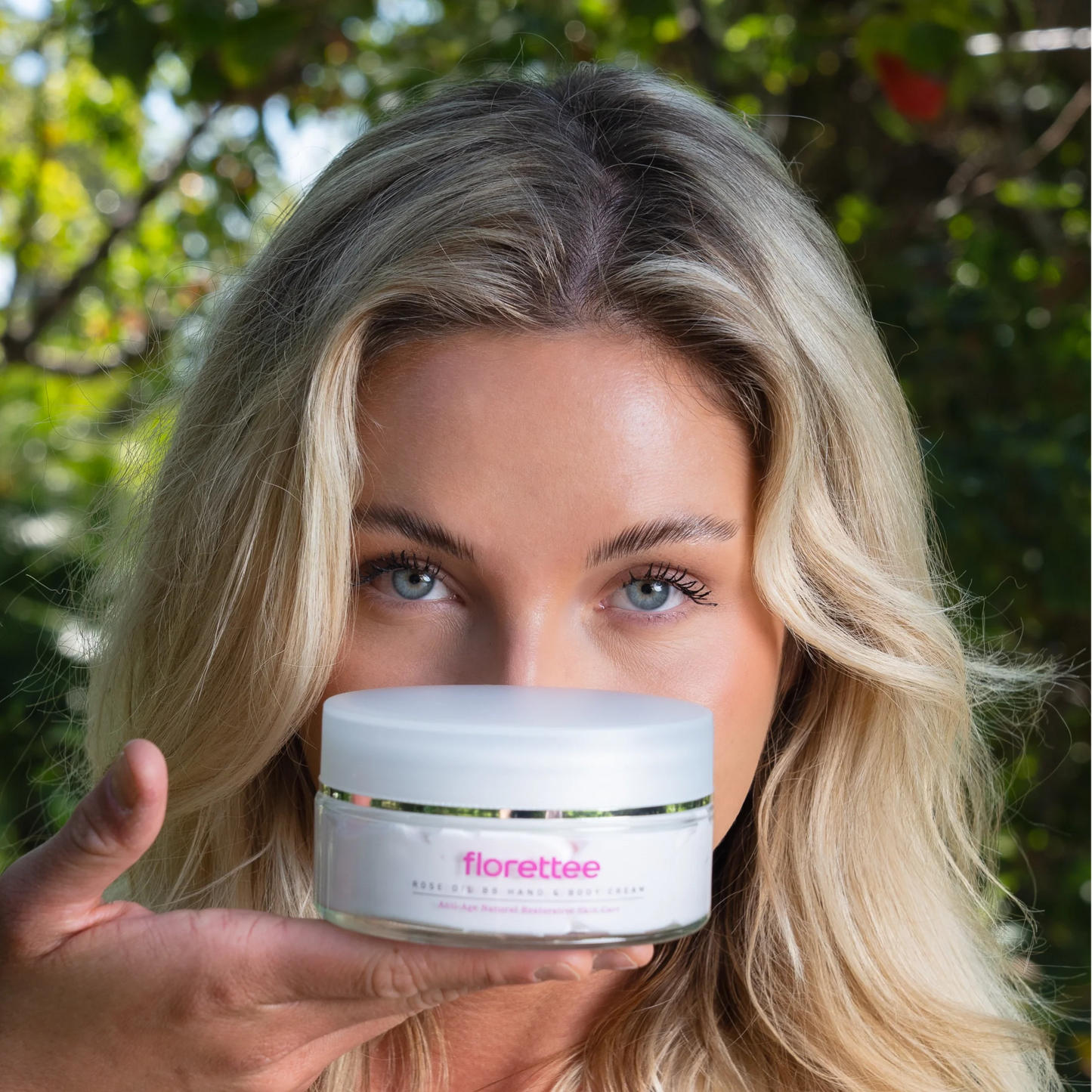 Model holding Florettee Rose Oil Hand and Body Cream