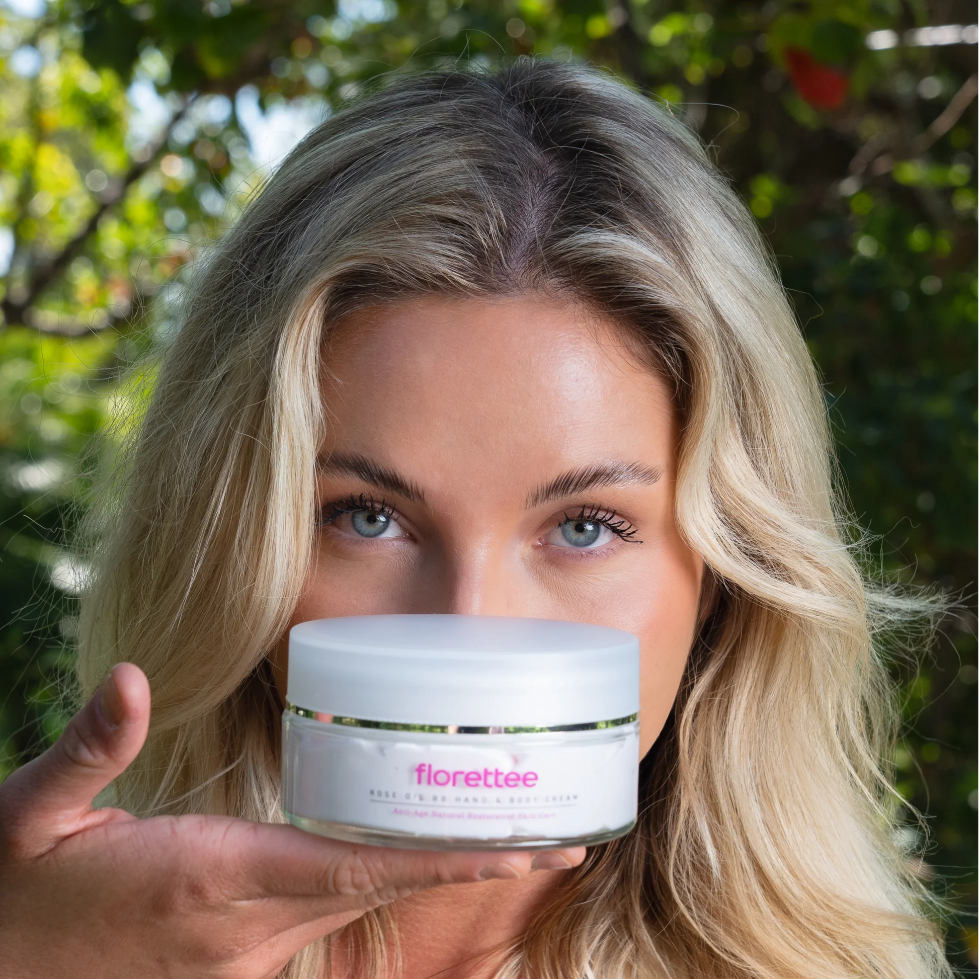Model holding Florettee Rose Oil Hand and Body Cream